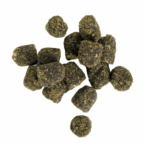 Piles of dark herbal balls on white background